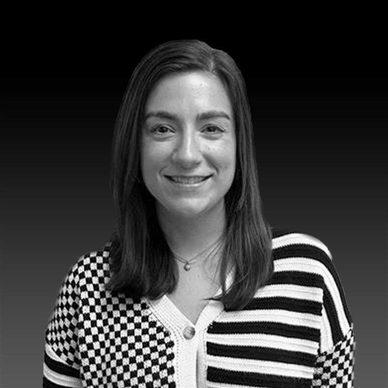 A black and white photo of Samantha Jones, smiling confidently at the camera.